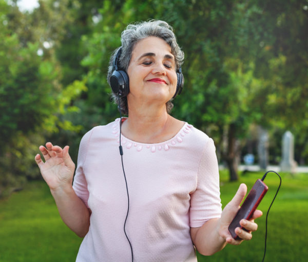 Woman with headphones dancing.