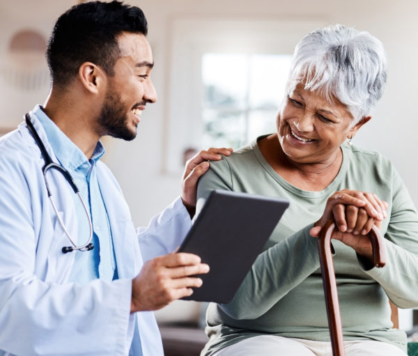 Shot of a young doctor sharing information from his digital tablet with an older patient